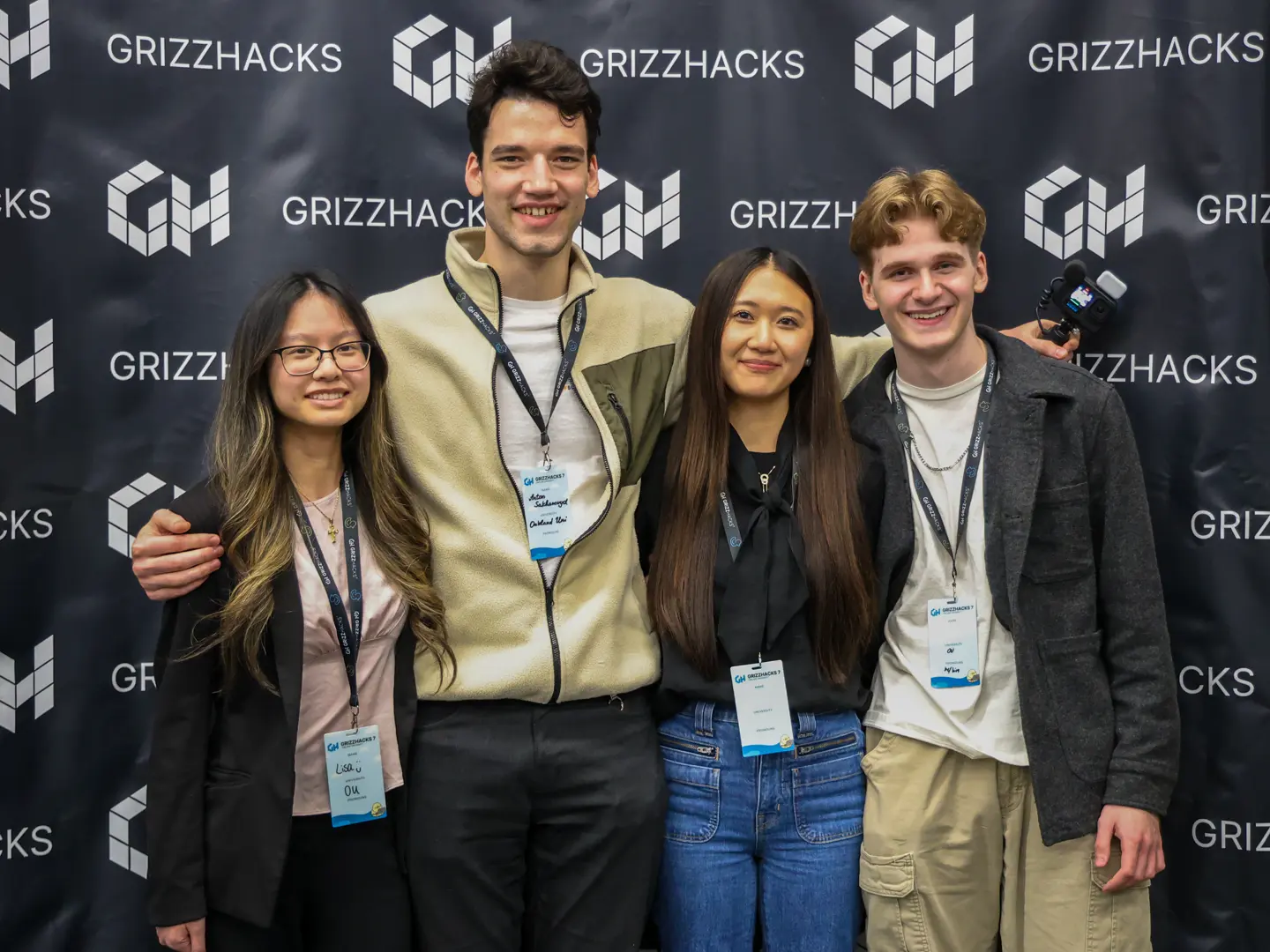 Us on the GrizzHacks photo wall after winning the best beginner hack award
